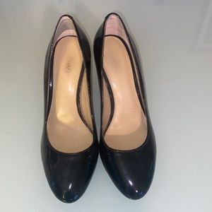 Michael Kors black round toe with gold heel pumps.